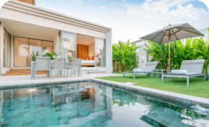 Home house exterior design showing tropical pool villa with greenery garden sun bed umbrella pool towels