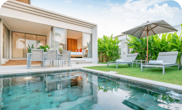 Home house exterior design showing tropical pool villa with greenery garden sun bed umbrella pool towels