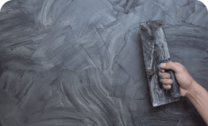 Plasterer renovating indoor walls