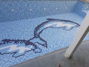 a swimming pool with a mosaic pattern